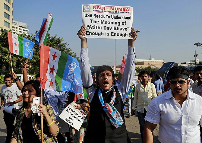 A member of the National Students Union of India (NSUI), the student wing of India's ruling Congress party, shouts slogans during a protest outside the U.S. consulate in Mumbai, India. 