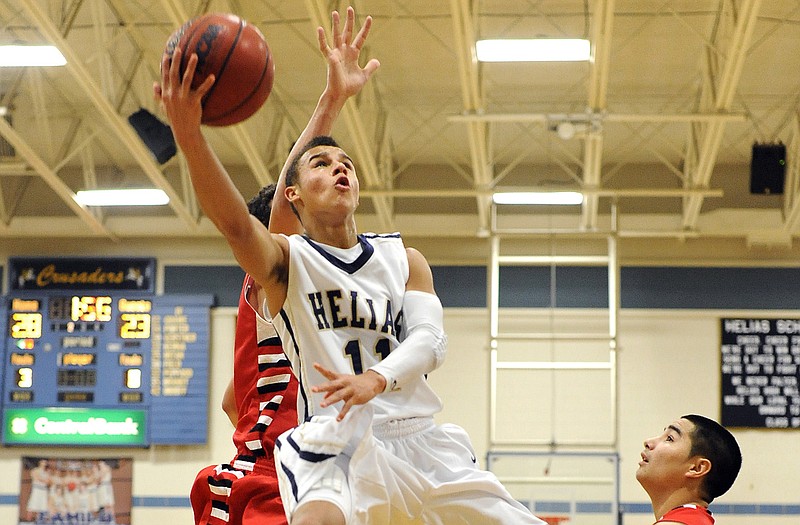 Helias' Isiah Sykes scores on a layup late in Friday's game against Branson at Rackers Fieldhouse.