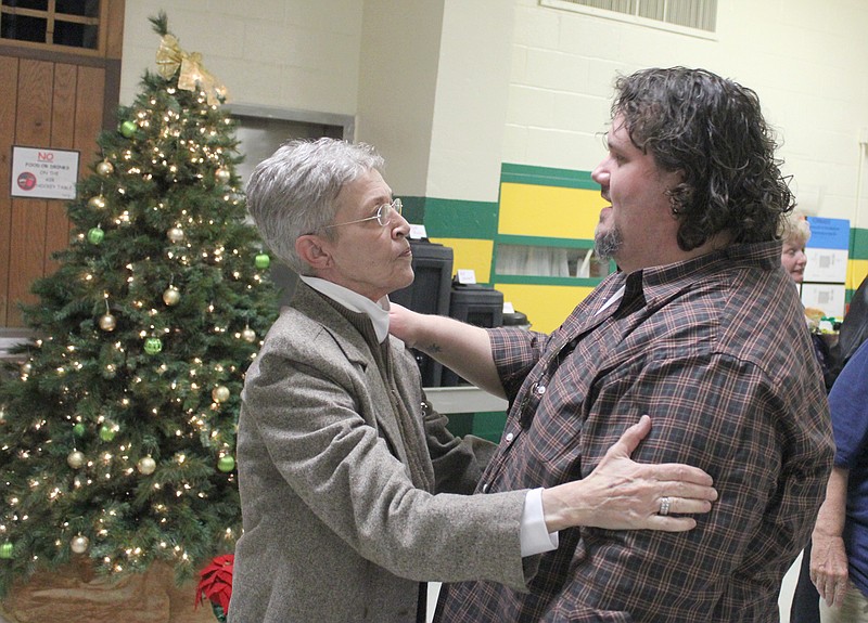 Outgoing Missouri School for the Deaf Superintendent Barbara Garrison receives a good-bye hug from teacher's aid Dan Isaac during her retirement reception Thursday afternoon. After 12 years at the helm, Garrison said she was leaving MSD to spend more time with family and allow a new leader to take over as the school looks to the future.