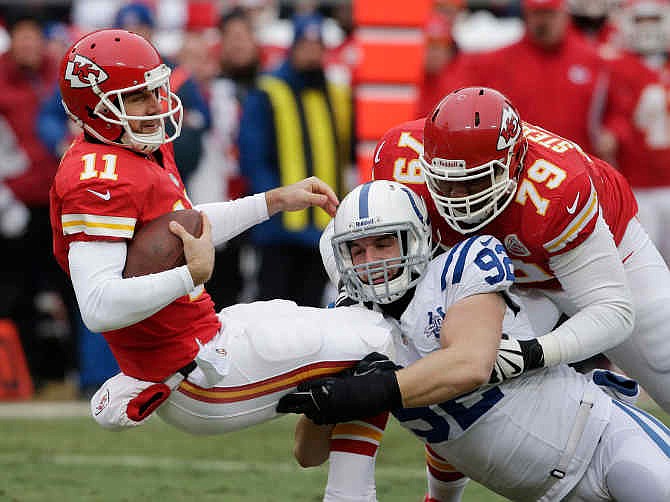 Kansas City Chiefs quarterback Alex Smith (11) is sacked by Indianapolis Colts outside linebacker Bjoern Werner (92) during the first half of an NFL football game at Arrowhead Stadium in Kansas City, Mo., Sunday, Dec. 22, 2013. Chiefs tackle Donald Stephenson (79) tries to block on the play. 