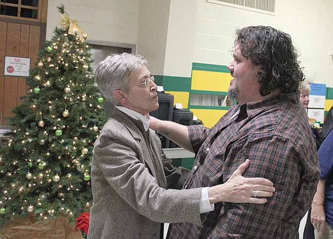 Outgoing Missouri School for the Deaf Superintendent Barbara Garrison receives a good-bye hug from teacher's
aid Dan Isaac during her retirement reception Thursday afternoon in Fulton.