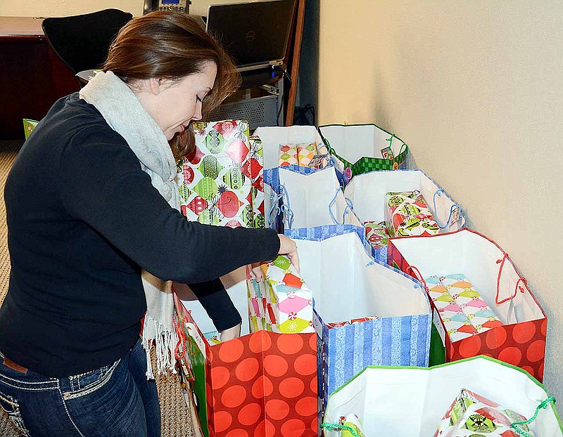 Co-Mo Accounting Clerk Margaret Sanders, who coordinates the cooperative's Giving Tree effort with Commerce Bank, Tipton, finishes packing gift bags for some of the 72 children Co-Mo adopted this year with donations from employees and board members.