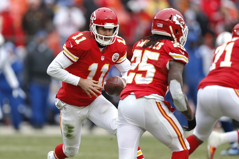 Chiefs quarterback Alex Smith hands off to running back Jamaal Charles during Sunday's game against the Colt. Both Smith and Charles could sit out this week's game.