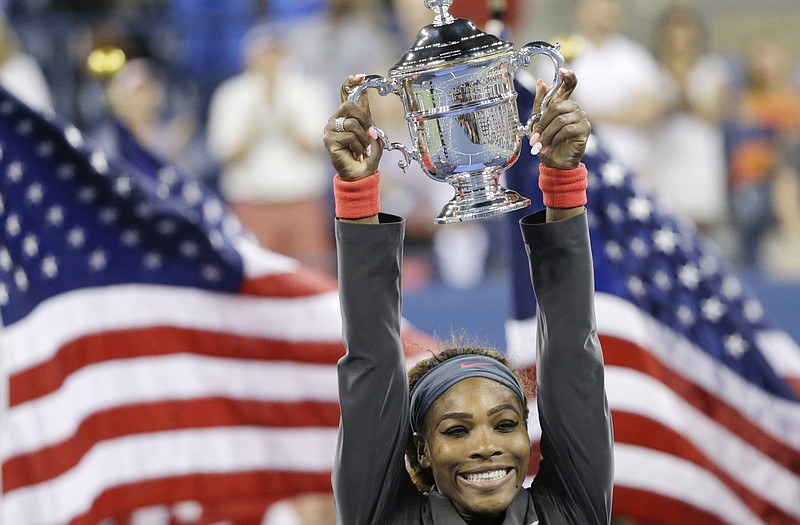 Serena Williams holds up the trophy after winning the 2013 U.S. Open.