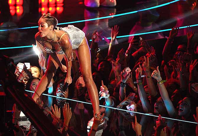  In this Aug. 25, 2013 file photo, Miley Cyrus performs at the MTV Video Music Awards at the Barclays Center in New York. Her infamous performance on the MTV Video Music Awards, showed her twerking her way in pop culture history in a teddy bear leotard that segues to a skimpy nude bikini. 