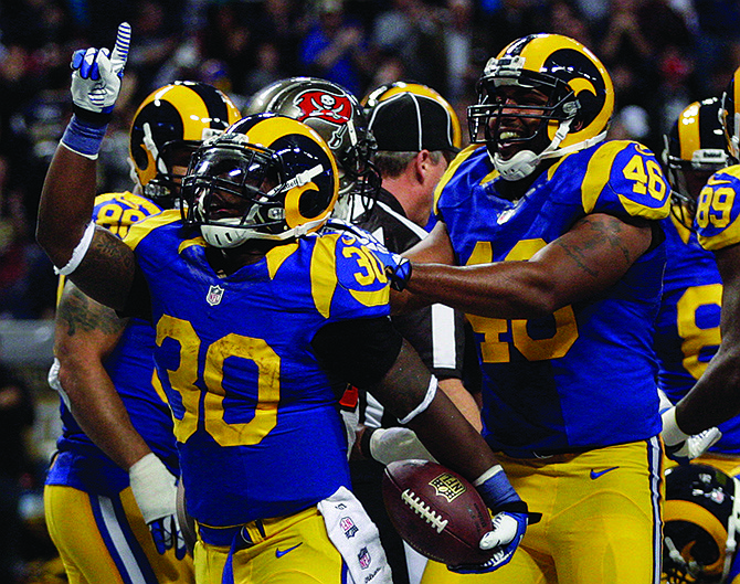 Rams running back Zac Stacy celebrates with teammate Cory Harkey (46) after scoring on a 1-yard run during the second quarter of last Sunday's game against the Buccaneers at the Edward Jones Dome.