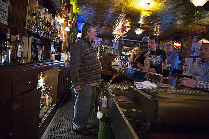Paddy Malone's owner Allen Tatman takes drink orders Friday afternoon. The bar is celebrating its 150th anniversary today. Tatman said the business is the oldest continually operating bar in Missouri.