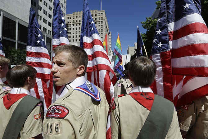  In this June 30, 2013 file photo, Boy Scouts from the Chief Seattle Council carry U.S. flags as they prepare to march in the Gay Pride Parade in downtown Seattle. The Boy Scouts of America, in the most contentious change of membership policy in a 103-year history, will accept openly gay youths in Scout units starting on New Year's Day 2014. 