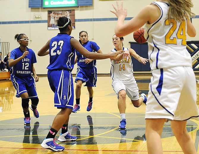 Fatima's Morgan Brandt fires a pass to Annie Bock in the post during Sunday's action in the State Farm Holiday Hoops Invitational at Rackers Fieldouse. Southeast's Brianna Harrison (23) and Indica Hawkins (12) defend.