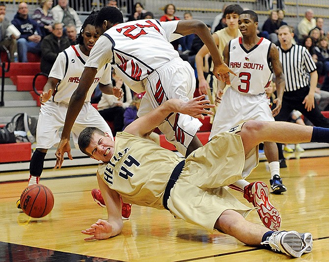 Helias' Trevor Koelling hits the deck while battling Raytown South's Elijah Childs (24) for a loose ball during Sunday's action in the Joe Machens Great 8 Classic at Fleming Fieldhouse.