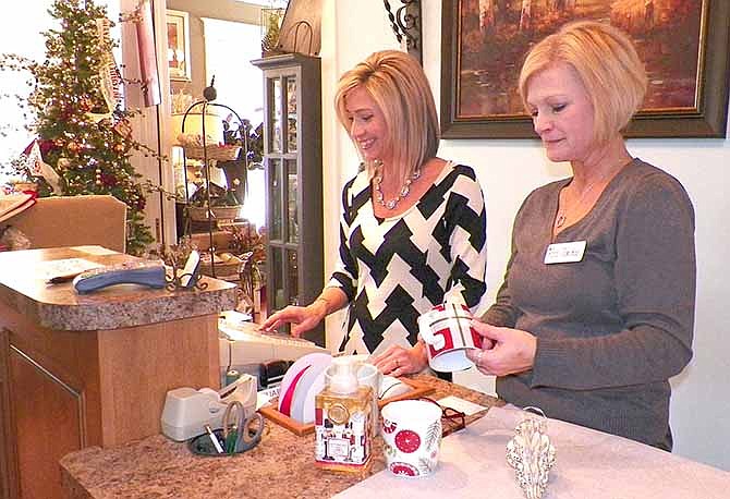 
The Schaefer House employees Angie Davis, left, and Jackie Russler ring up items for a customer buying from the post-Christmas sale. The shopping season isn't over yet, as many retailers look to sell their Christmas decor and consumers look for discounted items.