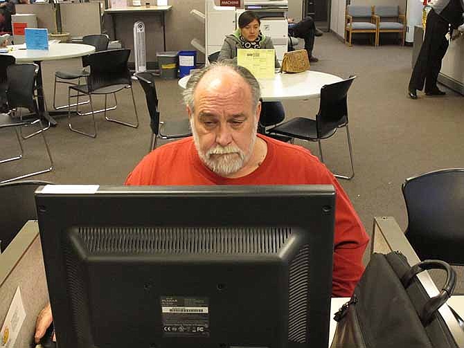 Richard Mattos, 59, looks for jobs at a state-run employment center in Salem, Ore., on Thursday, Dec. 26, 2013. Mattos is one of more than 1 million Americans who will lose federal unemployment benefits at year's end.