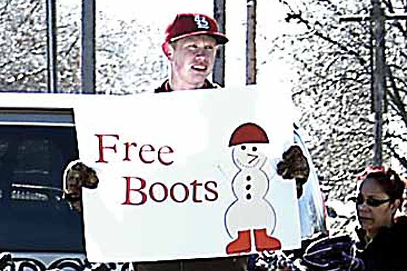 Democrat photo / David A. Wilson
Volunteers braved the cold Tuesday, Dec. 24, to give away snowboots at the Village Green Shopping Center. 