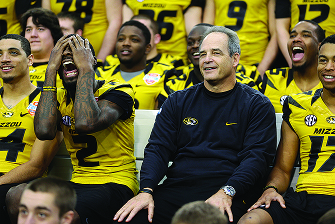 Missouri wide receiver L'Damian Washington (2) and coach Gary Pinkel react as they watch a photographer position himself to take a team photograph during AT&T Cotton Bowl Classic media day Monday in Arlington, Texas.