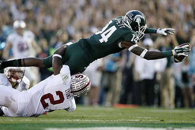 Michigan State wide receiver Tony Lippett scores a touchdown against Stanford's Wayne Lyons during the second half of the Rose Bowl NCAA college football game Wednesday, Jan. 1, 2014, in Pasadena, Calif. 