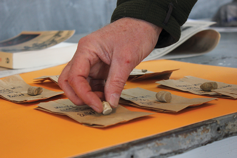 Lead archeologist Doug Scott picks up one of a number of bullets teams uncovered during a survey of the Moore's Mill battle site.