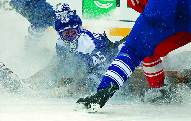 Maple Leafs goalie Jonathan Bernier stops a shot on goal during the second period of the Winter Classic game Wednesday against the Red Wings at Michigan Stadium in Ann Arbor, Mich.