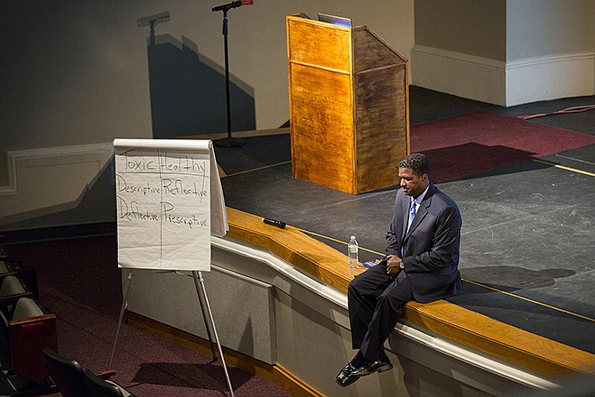 Speaker Anthony Muhammad sits on the stage during a group activity during the district-wide professional development conference Thursday morning at Miller Performing Arts Center. 