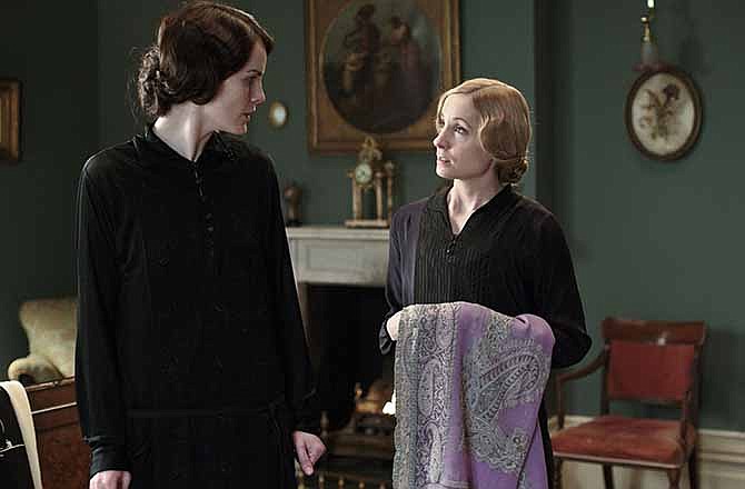 This photo released by PBS and Carnival Film and Television Limited shows, from left, Michelle Dockery as Lady Mary, and Joanne Froggatt as Anna Bates, in a scene from season four of the Masterpiece TV series, "Downton Abbey." As it returns for its much-awaited fourth season, "Downton Abbey" remains a series about elegance, tradition and gentility, and the pressures of preserving them. The show premieres Sunday, January 5, 2014 at 9 pm ET on PBS. 