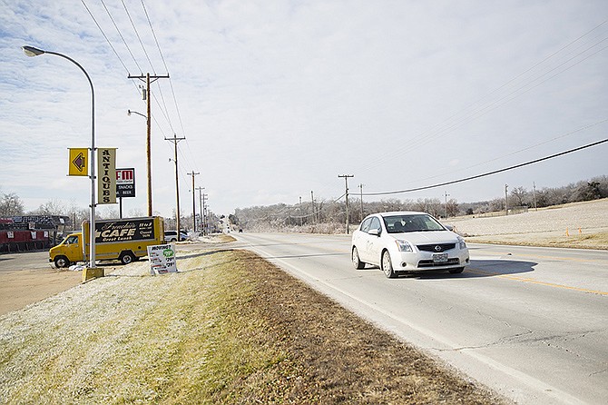 A car drives down Business Route 50 West. A planned reconstruction project will improve the Apache Flats section of the road between Country Club Drive and Binder Park. 