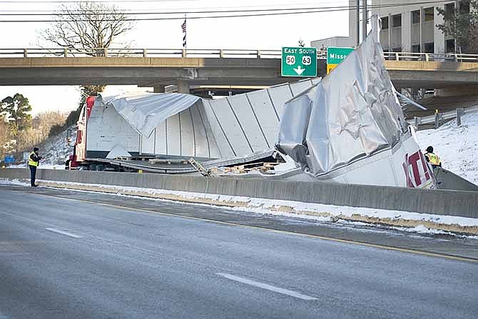 The contents of a Midwest Express semi-truck trailer lie scattered across the eastbound lane of U.S. Route 50 after an accident that temporarily shut down both west and east lanes early Friday evening.  Upon initial investigations, the driver appeared to lose control at the turn according to 1st Lt. Eric Wilde of the Jefferson City Police Department.