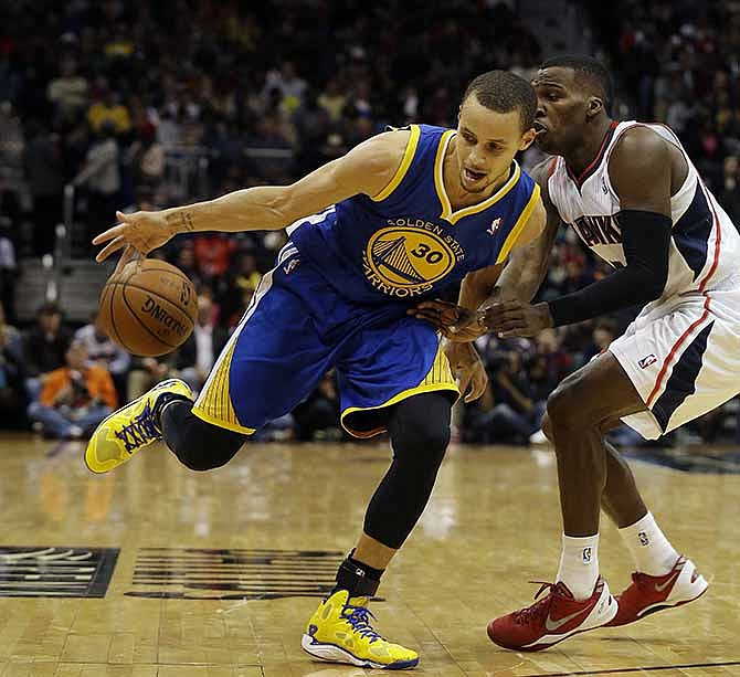 Golden State Warriors point guard Stephen Curry (30) drives against Atlanta Hawks point guard Shelvin Mack in the second half of an NBA basketball game on Friday, Jan. 3, 2014, in Atlanta. Golden State won 101-100.