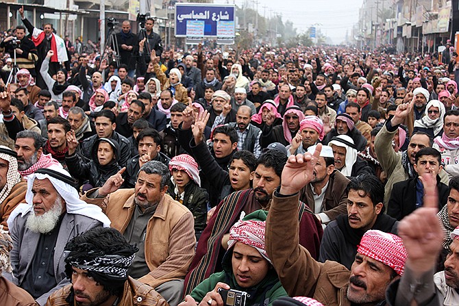 Sunni Muslim worshippers crowd a street Friday as they attend open air prayers in Fallujah, 40 miles west of Baghdad, Iraq. 