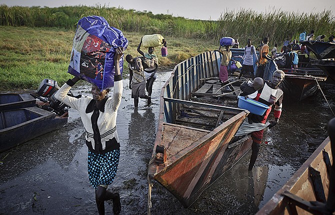 Some of the thousands of displaced people who fled the recent fighting between government and rebel forces in Bor by boat across the White Nile, arrive with what belongings they had in South Sudan.