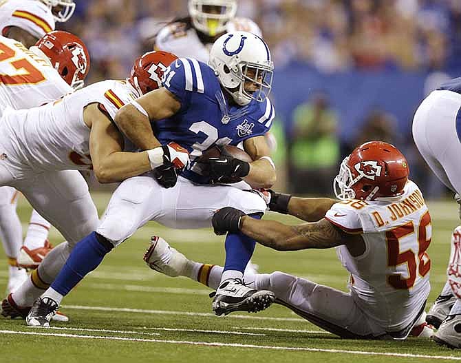 Indianapolis Colts' Donald Brown (31) is tackled buy Kansas City Chiefs' Derrick Johnson (56) during the second half of an NFL wild-card playoff football game Saturday, Jan. 4, 2014, in Indianapolis. 