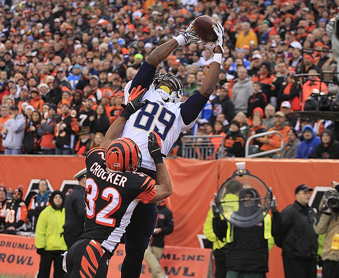 Chargers tight end Ladarius Green catches a 4-yard touchdown pass against Bengals safety Chris Crocker in the second half of their wild-card playoff game Sunday in Cincinnati.