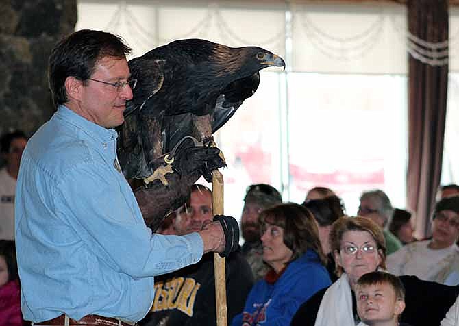 A World Bird Sanctuary handler shows off a golden eagle, native to the American West, during Saturday's Eagle Days program at Osage National Golf Resort.