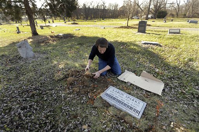 Aaron Pritchard replaces grass last month after laying a headstone on the previously unmarked grave of blues musician Aaron Sparks in Crestwood. Pritchard is part of the Killer Blues Headstone Project, a nonprofit effort to posthumously honor sometimes long-forgotten blues musicians with grave markers. The group has laid 22 headstones to date, with several more complete but awaiting placement. 