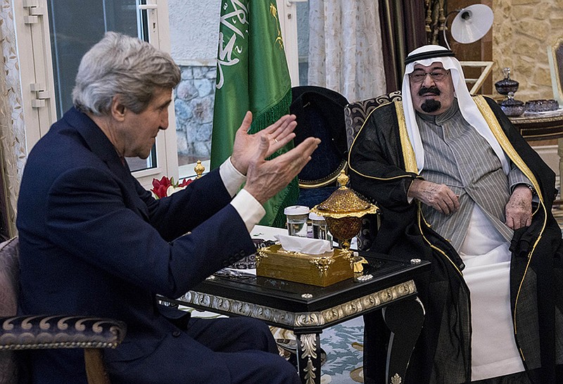 U.S. Secretary of State John Kerry, left, speaks with Saudi Arabia's King Abdullah before their meeting in Rawdat Khurayim, a secluded royal hunting retreat in Saudi Arabia, on Sunday.