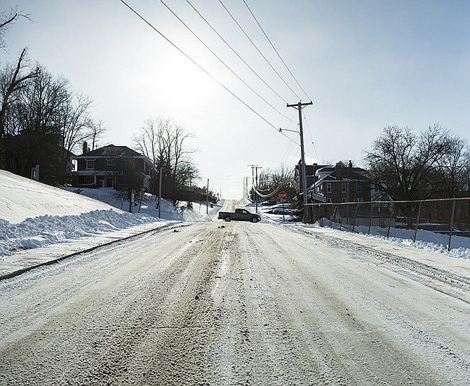 A truck crosses a snow-covered intersection Monday afternoon on Jackson Street.
