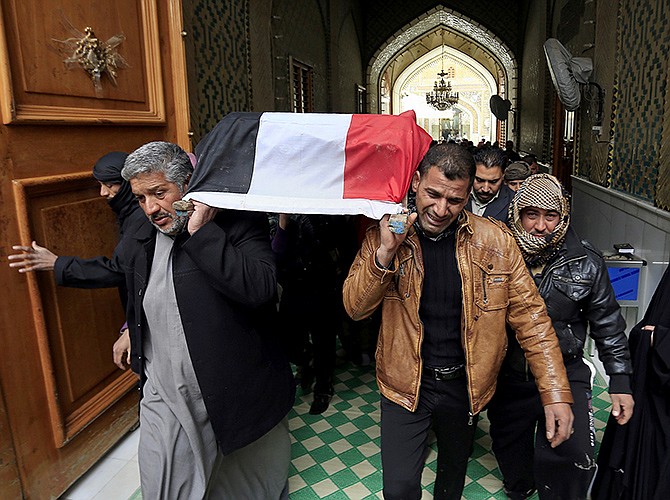 Mourners carry the flag-draped coffin of Iraqi soldier Layth Ahmed, who was killed during clashes in Ramadi.Clashes continued late Sunday and early morning Monday between al-Qaida and Iraqi troops on the main highway that links the capital, Baghdad, to neighboring Syria and Jordan.