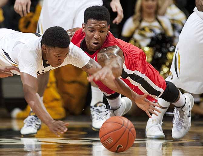 Georgia's Charles Mann, right, and Missouri's Wes Clark, left, battle for a loose ball during the first half of an NCAA college basketball game Wednesday, Jan. 8, 2014, in Columbia, Mo. 