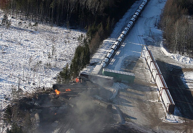 This aerial photo shows derailed train cars burning Wednesday in Plaster Rock, New Brunswick. A Canadian National Railway freight train carrying crude oil and propane derailed Tuesday night in a sparsely populated region.