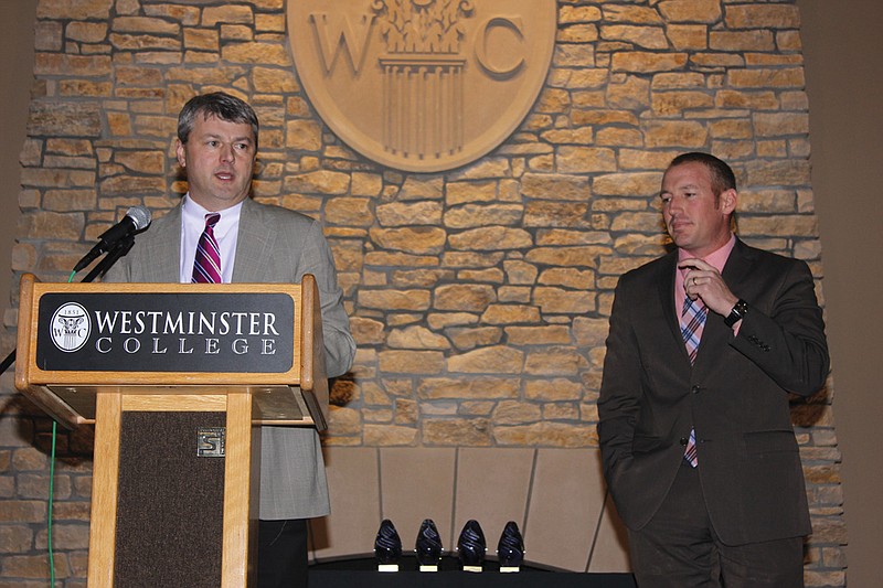Matt Gowin, left, addresses the Kingdom of Callaway Chamber of Commerce Banquet guests after ceremonially accepting the position of Chamber President from Matt Smith. Gowin said he had "big shoes to fill" following Smith, and noted his main goals as president would be to foster cooperation in working toward business solutions.