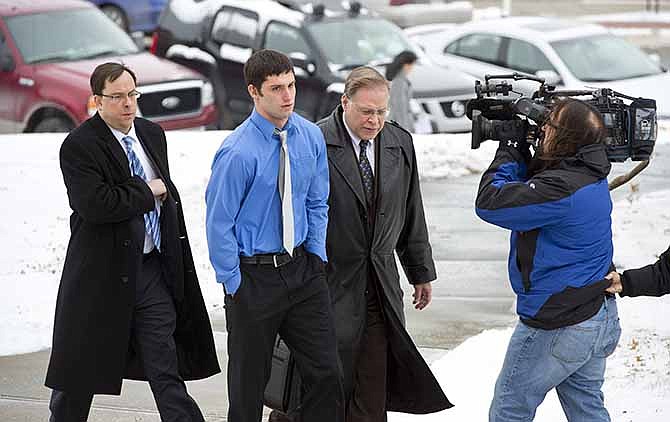 Matthew Barnett walks into the courthouse with his legal counsel David Bell, left, and J.R. Hobbs for a hearing on Thursday, Jan. 9, 2014 in Maryville, Mo. Barnett, accused of sexually assaulting a 14-year-old schoolmate when he was 17, has been charged with misdemeanor child endangerment. Special prosecutor Jean Peters Baker has been re-examining the girl's allegations that Barnett raped her at a January 2012 house party, when he was a Maryville High School senior and she was a freshman. (AP Photo/The Kansas City Star, The Kansas City Star)