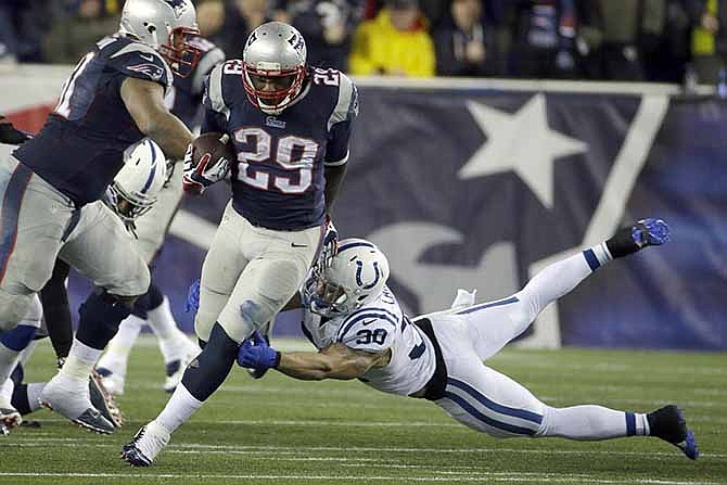 New England Patriots running back LeGarrette Blount (29) breaks free from Indianapolis Colts safety LaRon Landry (30) and heads downfield for a touchdown during the second half of an AFC divisional NFL playoff football game in Foxborough, Mass., Saturday, Jan. 11, 2014. 