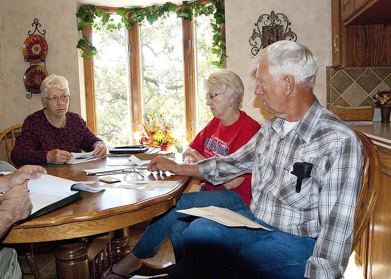 From left: Della Braun, Helen LePage, and Dave Van Loo discuss memories of their father, Emil Van Loo (inset at left), who was a veteran of the First World War and severely wounded in the Meuse-Argonne offensive. They have pieced together much of his military service using newspaper articles and military records. 