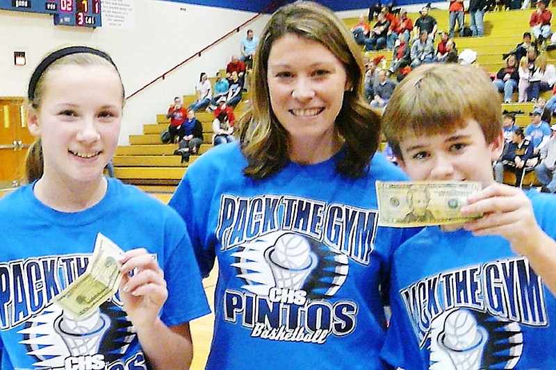 Seventh grade Hoop Shoot Participants
Democrat Photo/Paula Earls
During halftime of the girls varsity basketball game Friday night, Hailey Cain, left, and Austin Bolin, right, were winners of $20 for connecting on a basket.  The event was sponsored by Hawthorn Bank.  Presenting the money to the students is Becky Lawson, center, Hawthorn Bank Branch Manager.