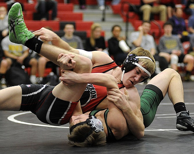 Jefferson City's Zack Hurley grapples with Rock Bridge's Jason Kiehne in a 138-pound matchup Tuesday night at Fleming Fieldhouse.