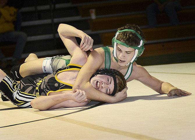 Fulton junior Dawson Connor struggles to free himself beneath Blair Oaks freshman London Gaydos' grip during their match Thursday night in Wardsville. Gaydos won the match by fall against Connor in the 120-pound weight class.