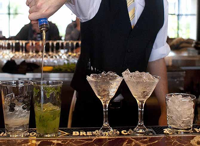 In this Monday, Nov. 19, 2012 file photo, a bartender prepares alcoholic drinks at a restaurant in San Francisco.