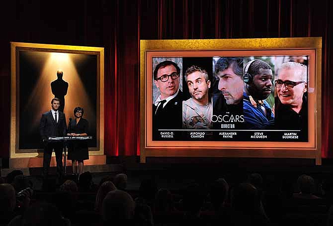 Actor Chris Hemsworth, left, and President of the Academy Cheryl Boone Isaacs announce the Academy Awards nominations for Best Director at the 86th Academy Awards nomination ceremony on Thursday, Jan. 16, 2014 in Beverly Hills, Calif. The 86th Annual Academy Awards will take place on Sunday, March 2, at the Dolby Theatre in Los Angeles. 