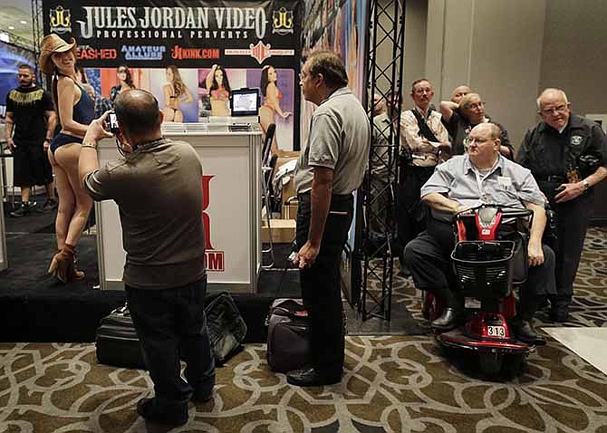 Porn industry affiliates and fans wait in line for an autograph from porn star Riley Reid at the Adult Entertainment Expo, Wednesday, Jan. 15, 2014, in Las Vegas. Potential opportunities for X-rated film production in Nevada were the talk of the Expo at the Hard Rock hotel and casino this week, sparked by a Los Angeles law requiring male actors to wear condoms.