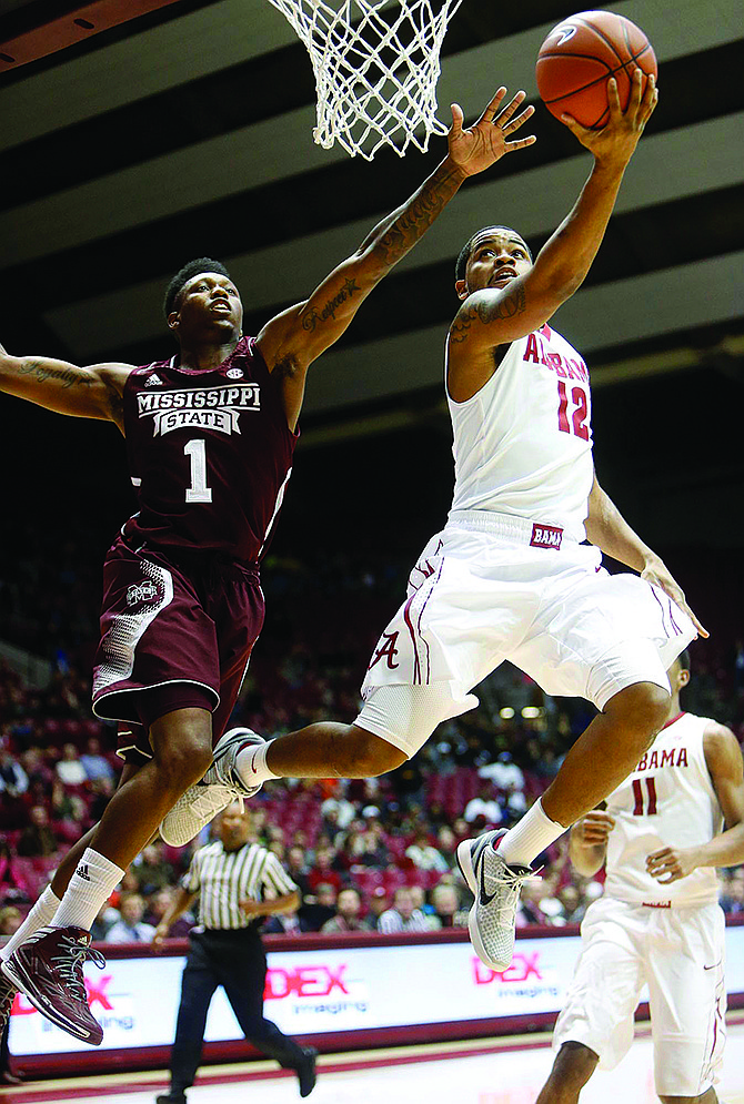 Alabama's Trevor Releford takes the ball to the basket while being pressured by Mississippi State's Fred Thomas during a game Wednesday in Tuscaloosa, Ala.