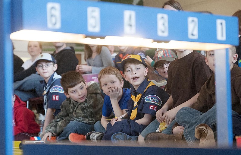 A young Cub Scout reacts as he and his fellow scouts watch pinewood derby cars speed past the finish line on Saturday inside the Fulton State Hospital's Main Canteen. Tiger Cubs, Wolves, Bears, Webelos and Webelos 2 of Cub Scout Pack 50 raced in the morning and the older age group raced in the afternoon. All participants received a ribbon and trophies were awarded to first, second and third place winners.