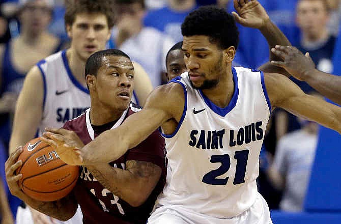 Fordham's Chris Whitehead, left, looks to pass as Saint Louis' Dwayne Evans defends during the second half of an NCAA college basketball game Saturday, Jan. 18, 2014, in St. Louis. Saint Louis won 70-48. 